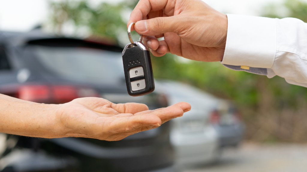 Private car sale with buyer and seller discussing loan payoff