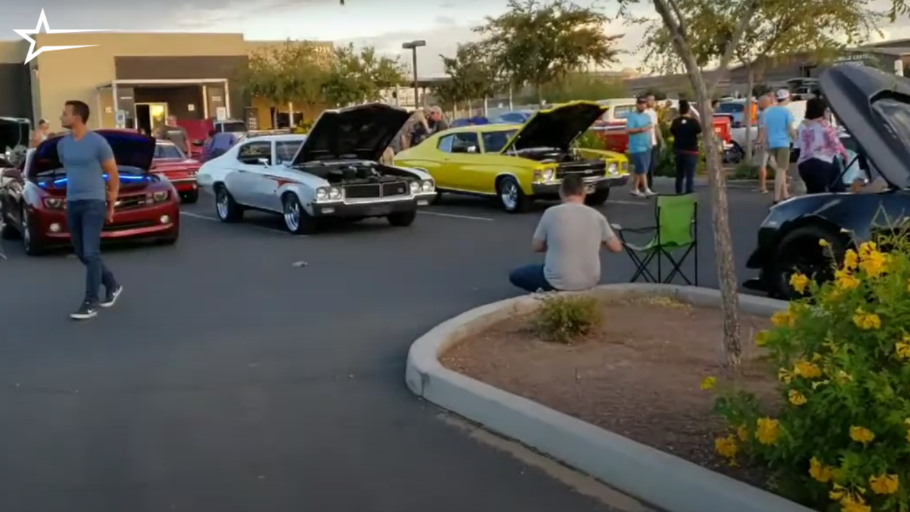 A lineup of classic cars displayed at the Rock Point Church Car Show, with visitors admiring vintage models under sunny skies.